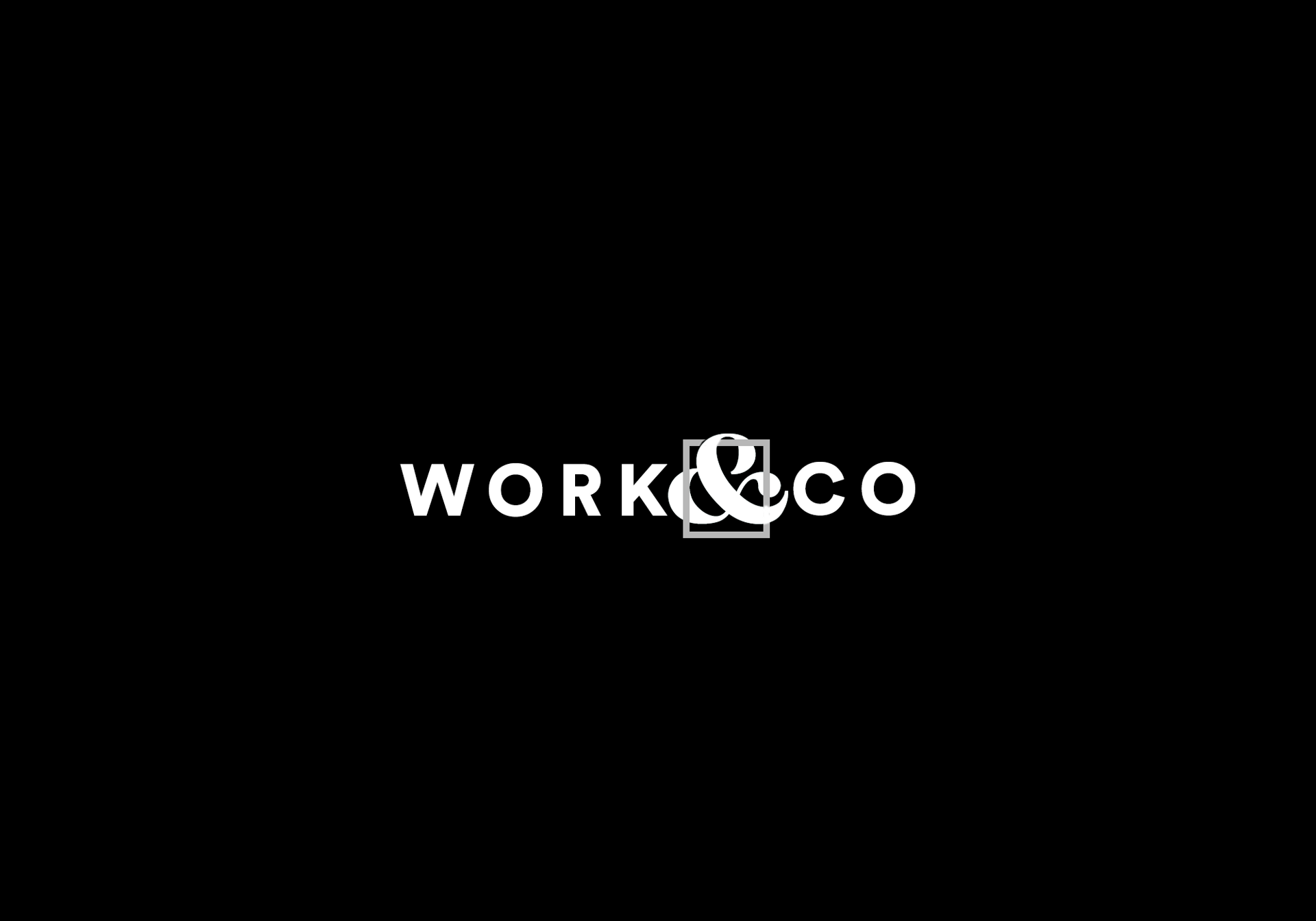 Early logo concept — ampersand-in-box on black